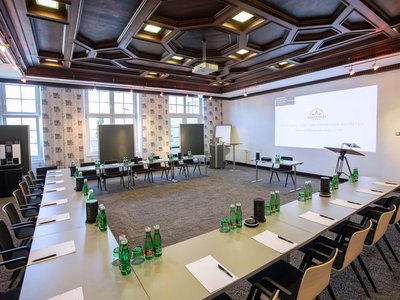 Seminar rooms at Hotel Böhlerstern: music room Large conference room with U-shaped tables, chairs, and bottles of water