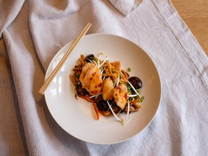 Restaurant Bachstelze in Kapfenberg Asiatisches Gericht mit Hähnchen, Pilzen, Nudeln und Mungobohnenkeimen auf weißem Teller