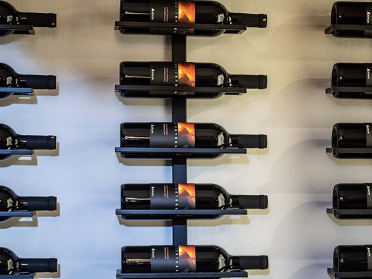 Seminar rooms at Hotel Böhlerstern: our Genusslabor® Wine bottles displayed on a modern metal wall rack